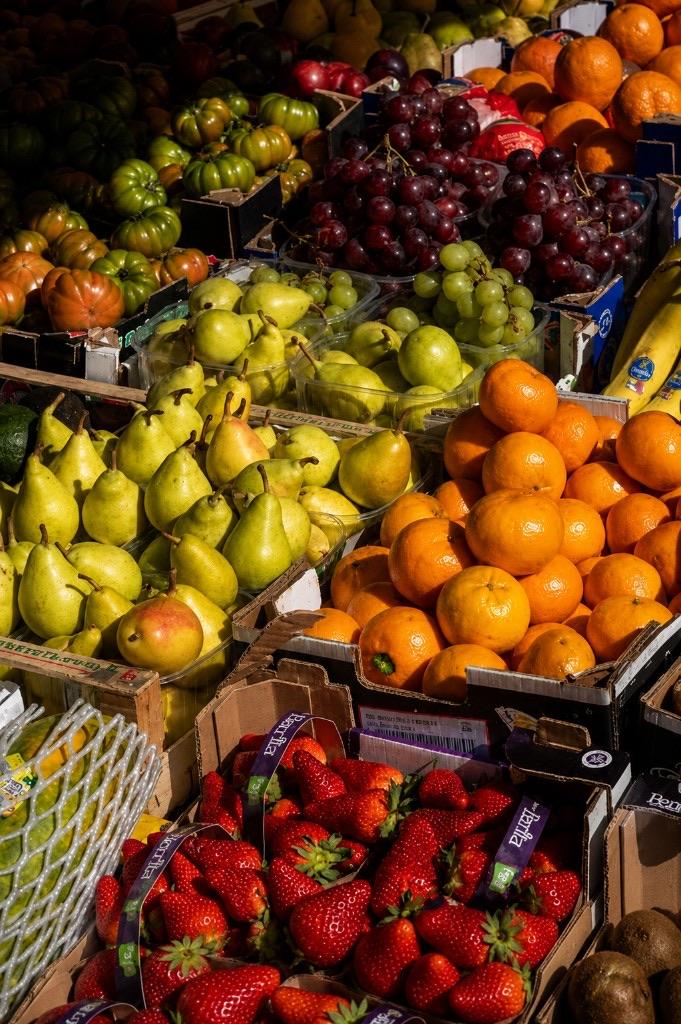 Pears, citrus, grapes and strawberries packed in market crates.